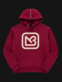 A maroon pullover hoodie featuring a cream-colored square graphic with a stylized 'MB' logo on the chest, displayed against a solid white background.